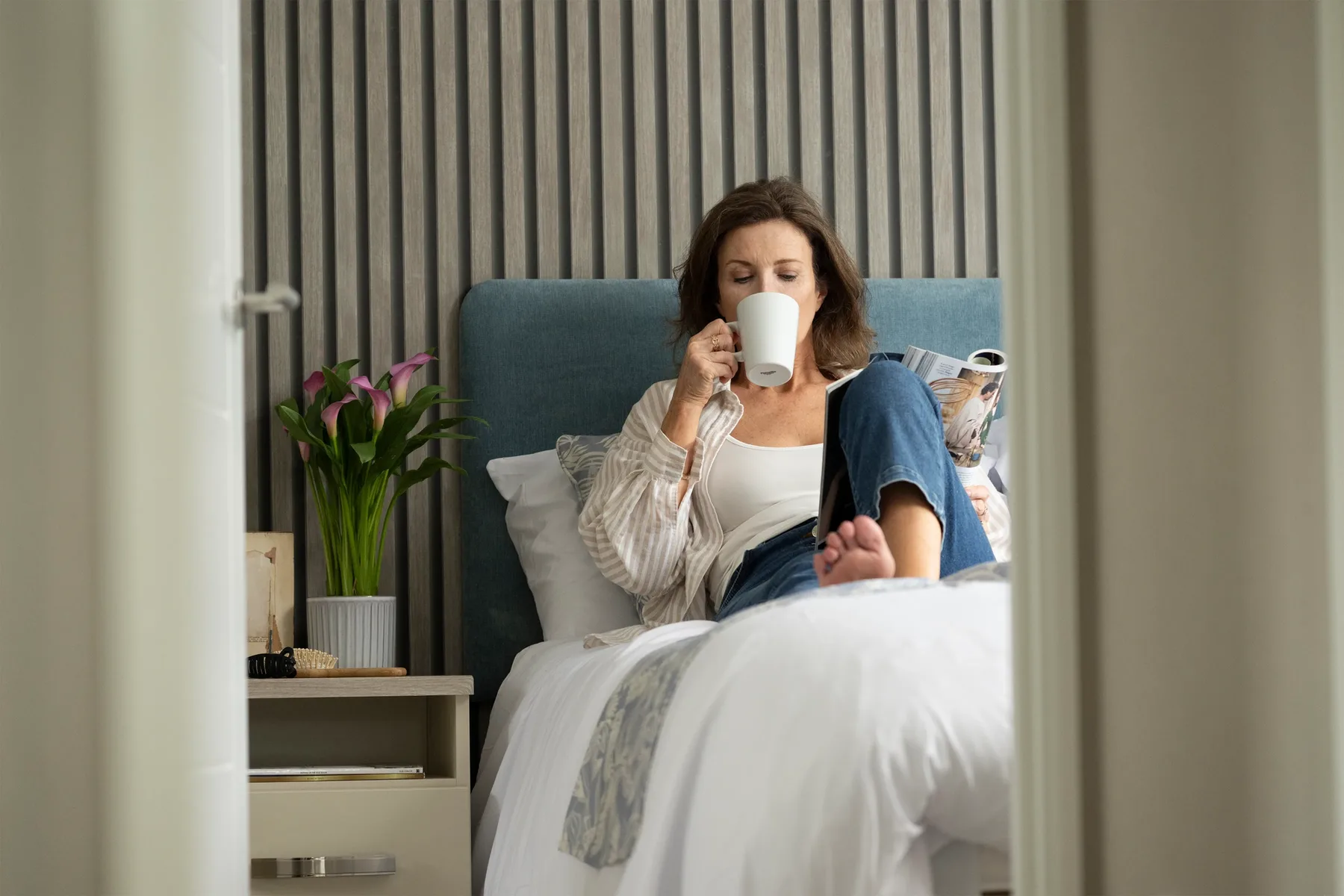 Woman drinking tea in bed