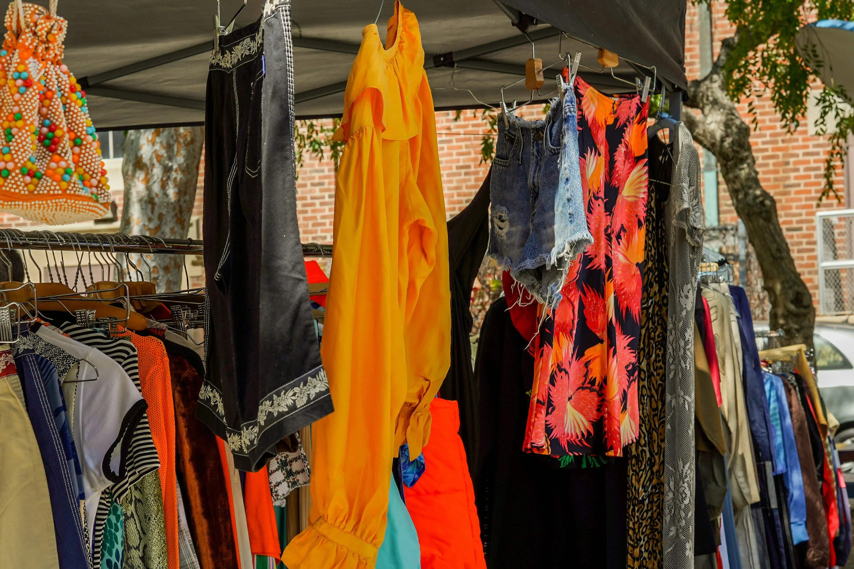Dorset weekly markets 3 Clothes hanging up in a market stall