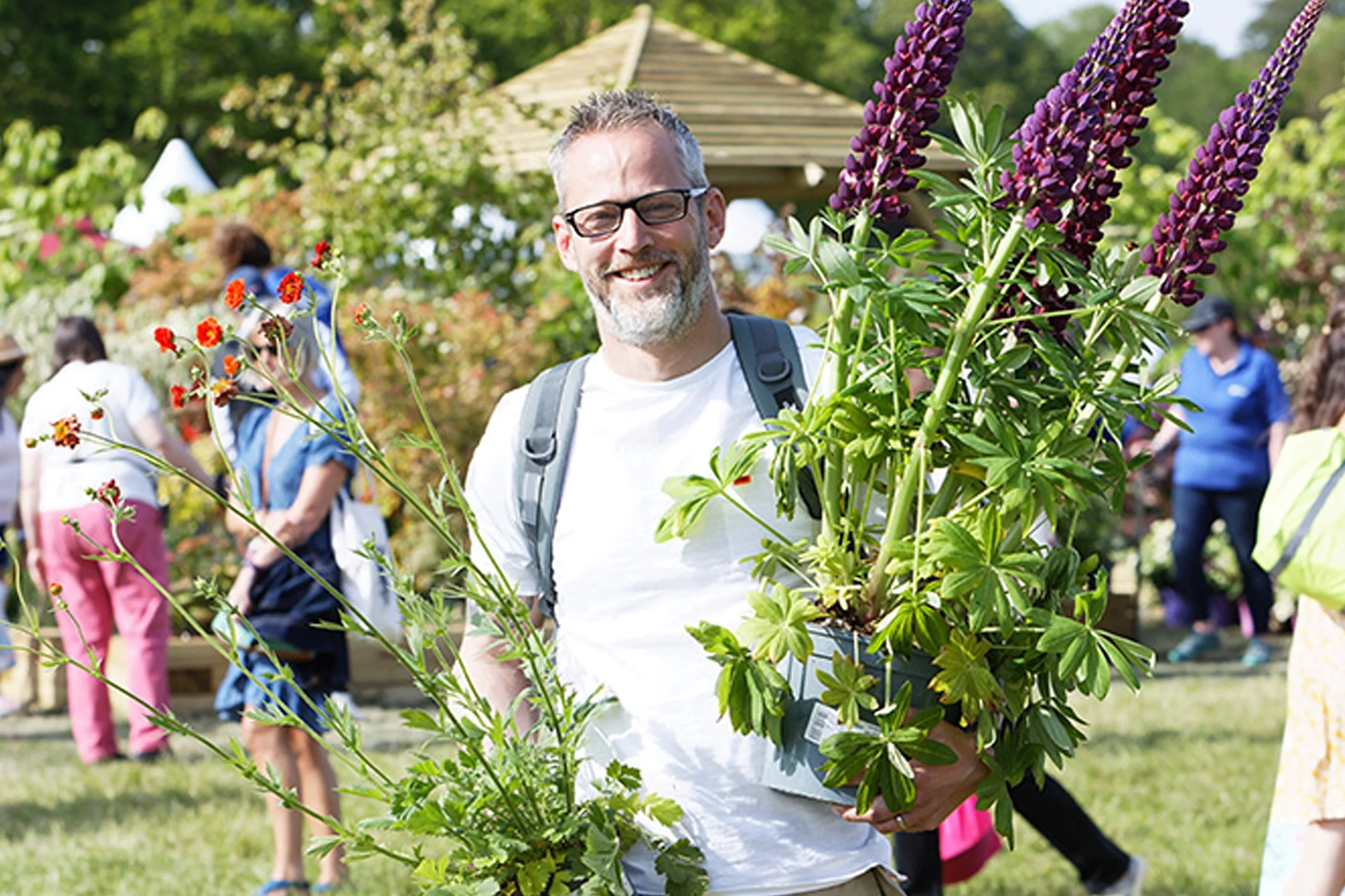 Visitors exploring garden displays at a spring gardening show