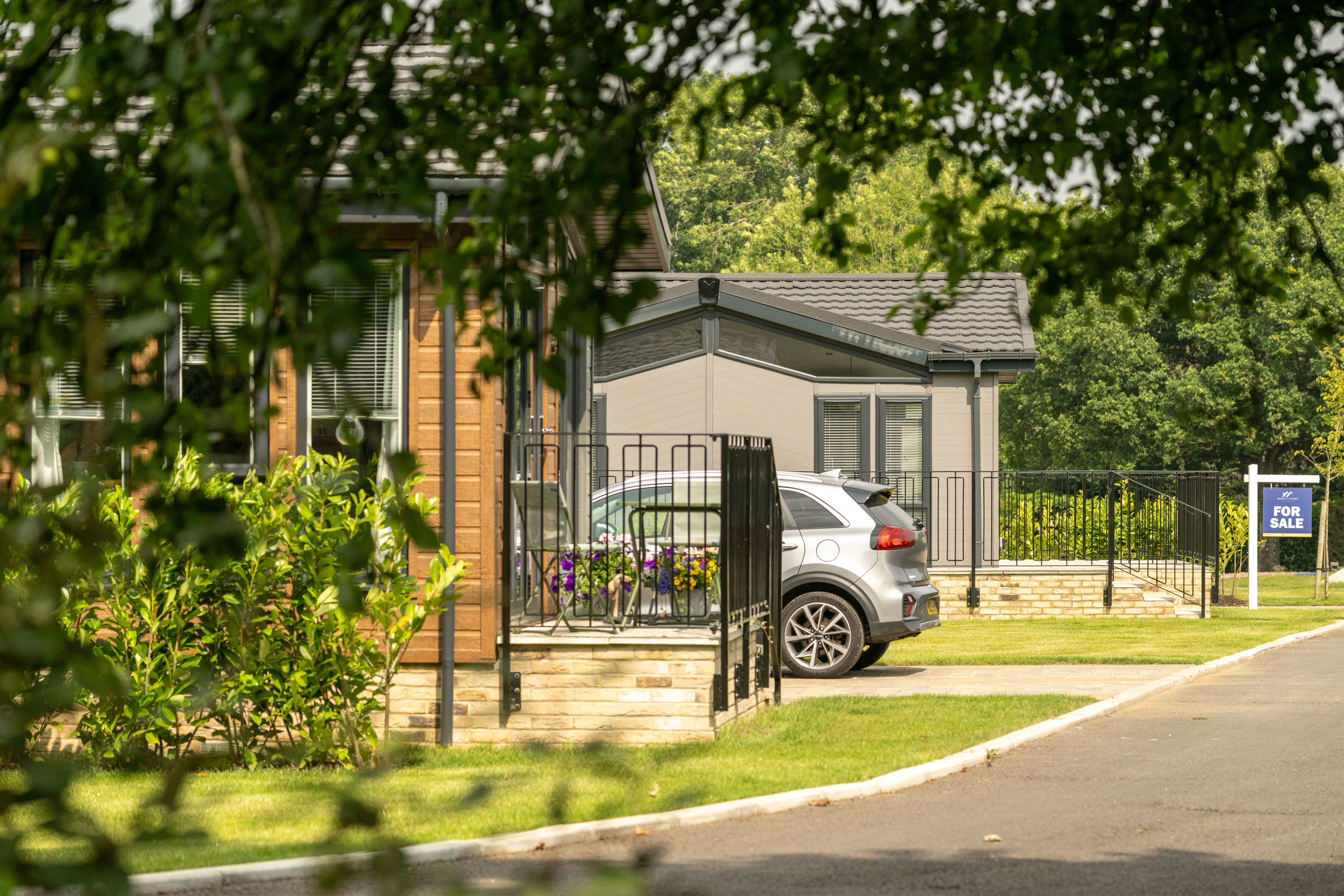 View under trees of car in drive CTA