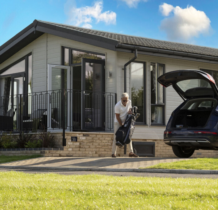Man loading golf club into car Square