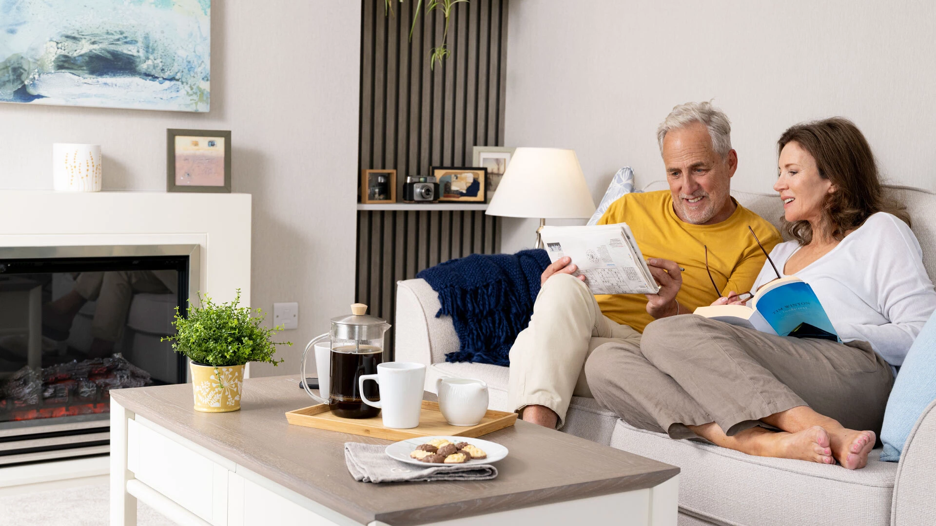 Couple looking at brochure on sofa Header
