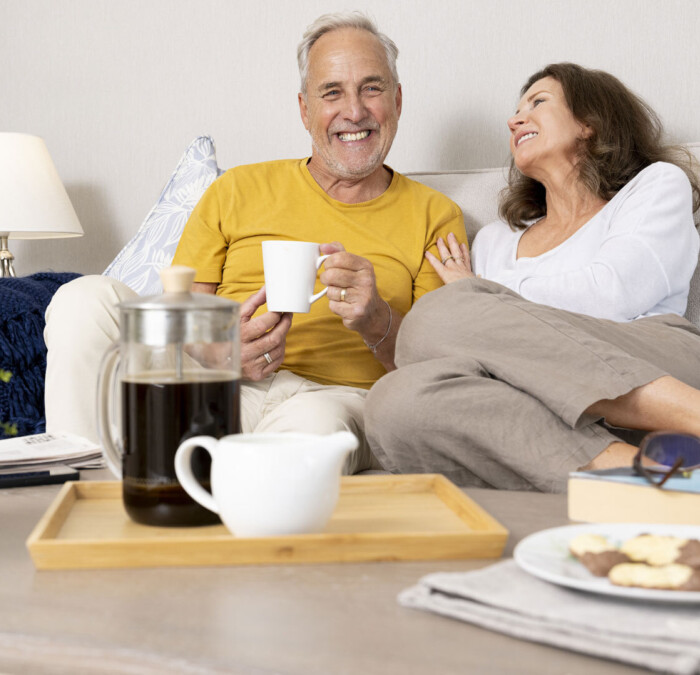 Models chatting over coffe and biscuits Square