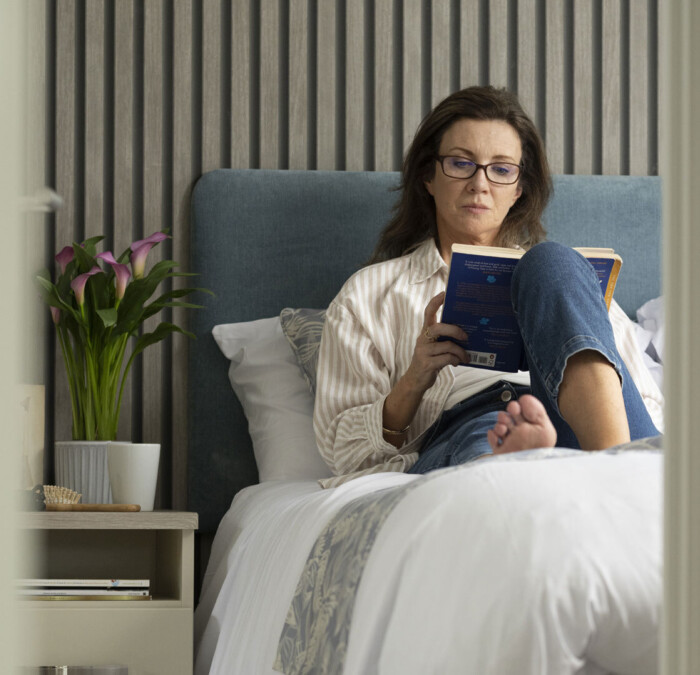 Woman reading on bed Square
